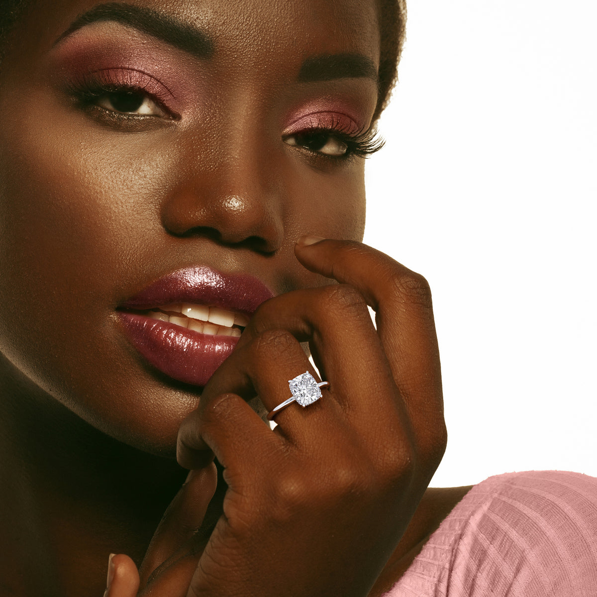Elegant cushion-cut diamond ring in 14K, 18K, or platinum on a woman's hand, showcasing luxury and fine craftsmanship for special occasions. 