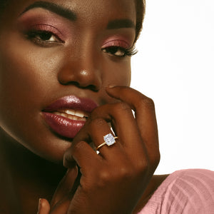 Close-up of a model wearing a radiant-cut diamond ring in 14K gold, 18K gold, or platinum, epitomizing elegance and fine craftsmanship. 