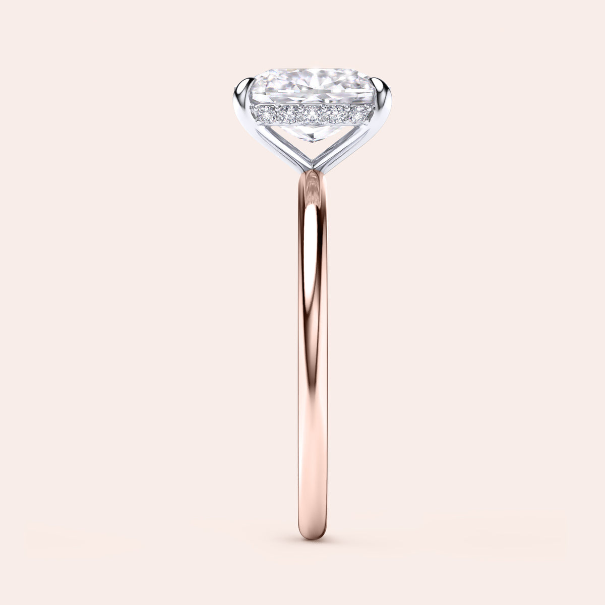 Two-tone 14K/18K gold diamond ring featuring a cushion-cut stone with secret halo, set in white and rose gold. 