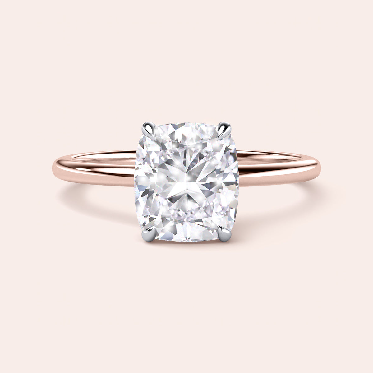 Two-tone 14K rose and white gold cushion-cut diamond engagement ring with secret halo design, perfect for timeless elegance. 