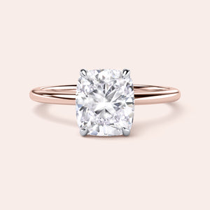 Two-tone 14K rose and white gold cushion-cut diamond engagement ring with secret halo design, perfect for timeless elegance. 