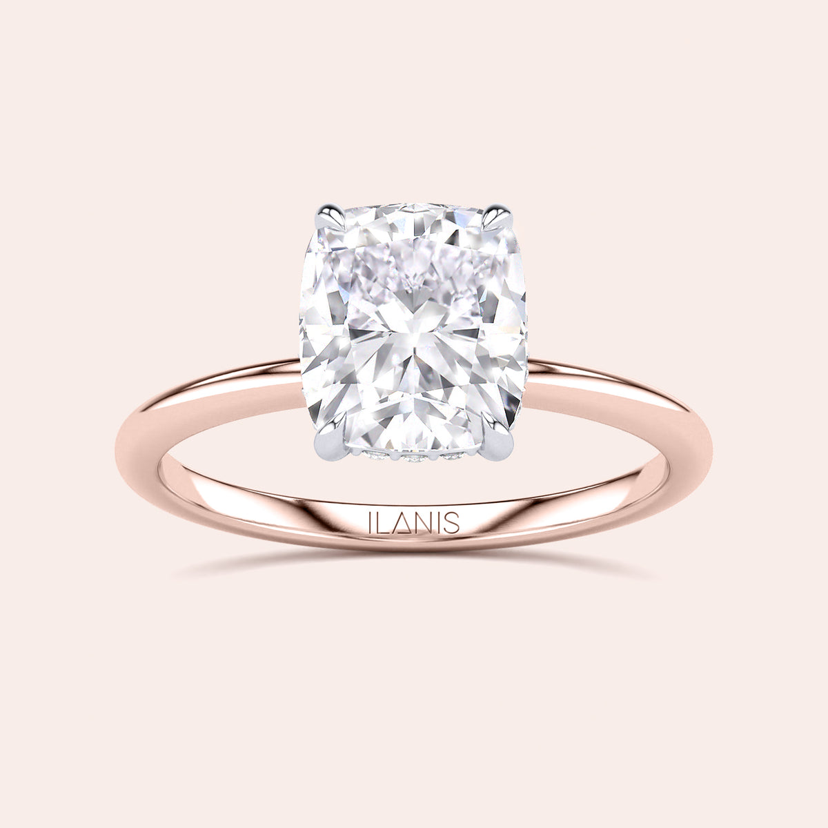 Two-tone 14K/18K rose and white gold engagement ring featuring a cushion-cut diamond in a secret halo setting. 