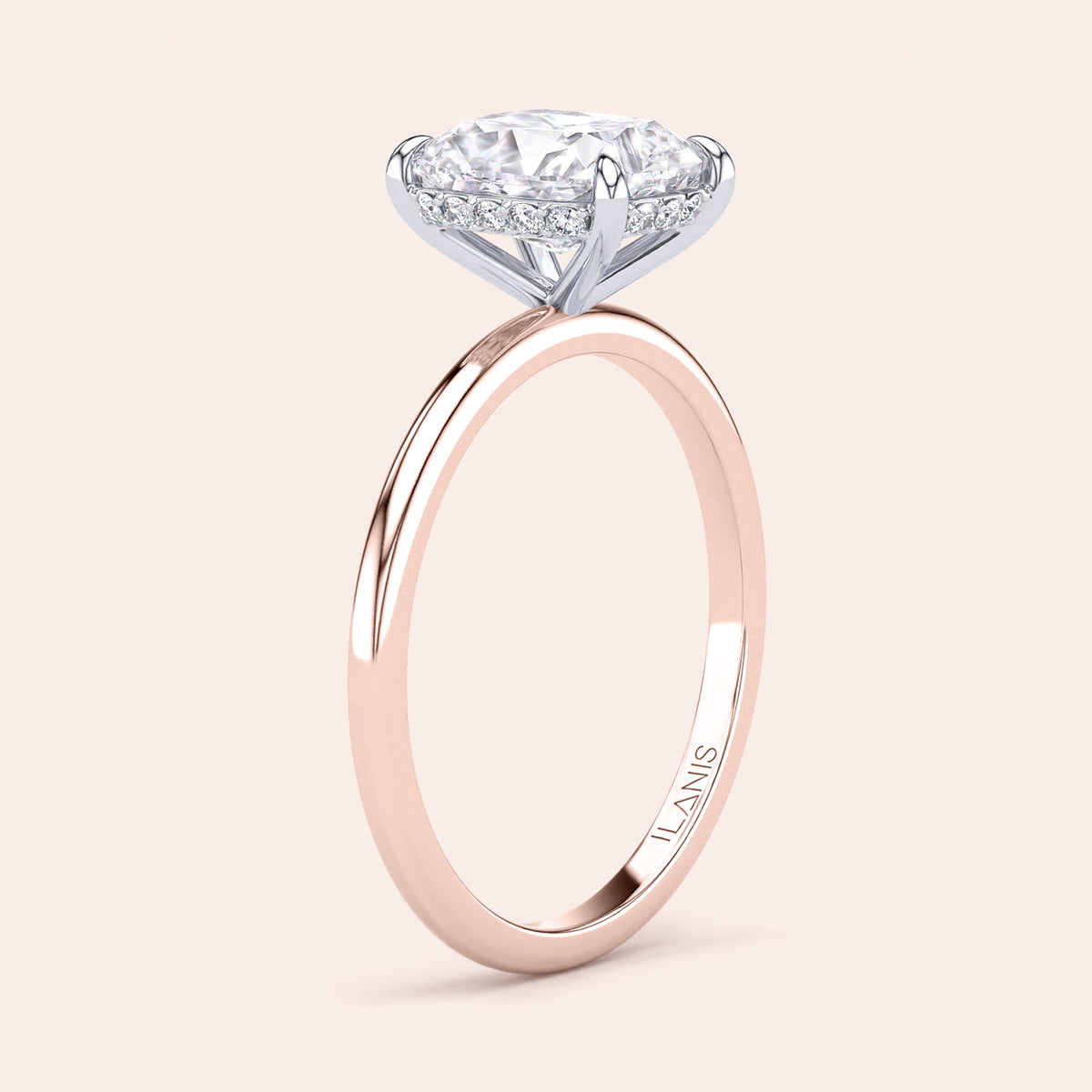 Two-tone 14K/18K white and rose gold diamond solitaire ring featuring a cushion-cut design and secret halo. 