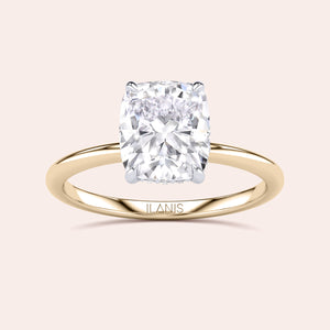 Two-tone 14K/18K white and yellow gold cushion-cut diamond ring, featuring a secret halo design, perfect for engagement or weddings. 