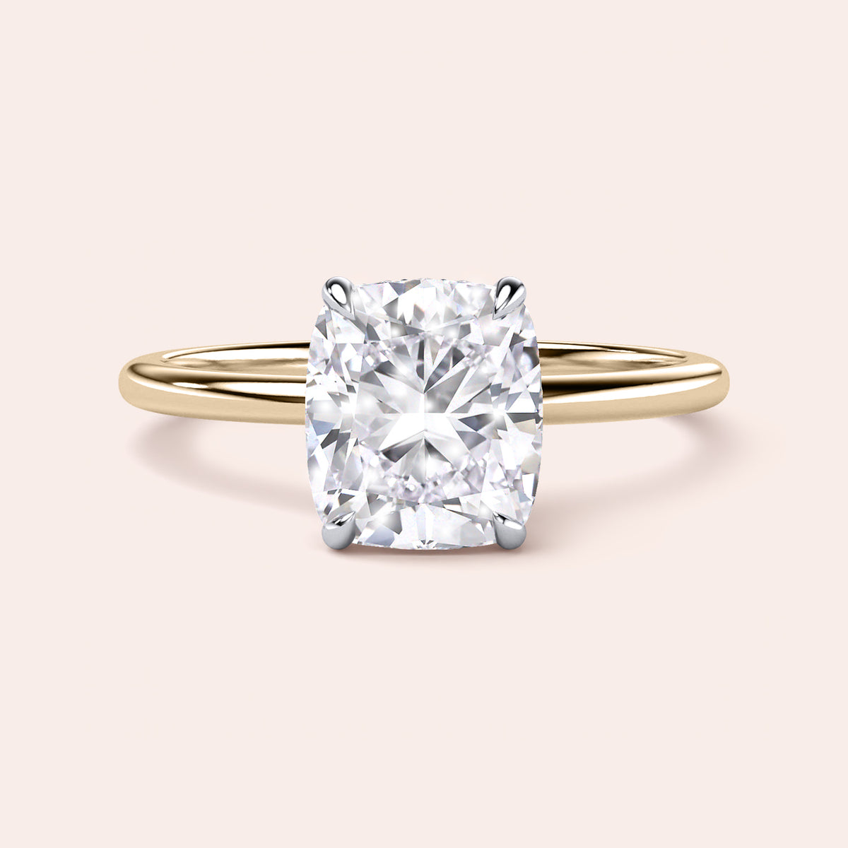 Two-tone 14K/18K gold engagement ring featuring a cushion-cut diamond in white and yellow gold. 