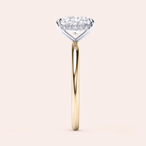 Two-tone 14K/18K gold cushion cut diamond secret halo solitaire ring in yellow and white gold, perfect for engagements. 