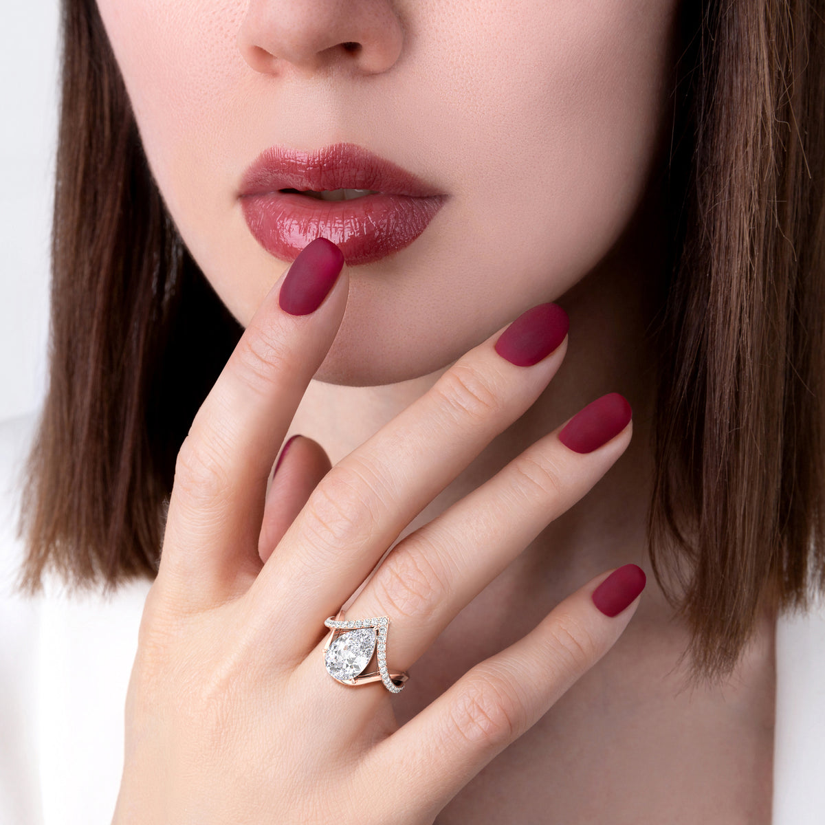 Luxurious pear-shaped diamond ring in 14K gold, elegantly worn on model's hand, perfect for special occasions and timeless style.