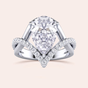 Stunning 14K, 18K, or platinum ring with a pear-shaped diamond and smaller accent diamonds for added brilliance.