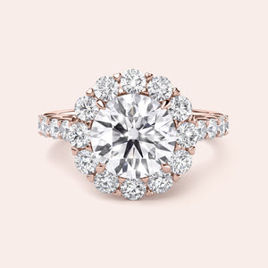 Exquisite halo engagement ring showcasing a round diamond in a stunning 14K or 18K gold or platinum band with smaller sparkling diamonds.