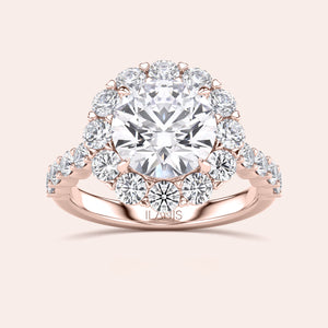 Rose gold diamond halo engagement ring with a round diamond center, accented with sparkling diamonds. Available in 14K, 18K, or platinum.