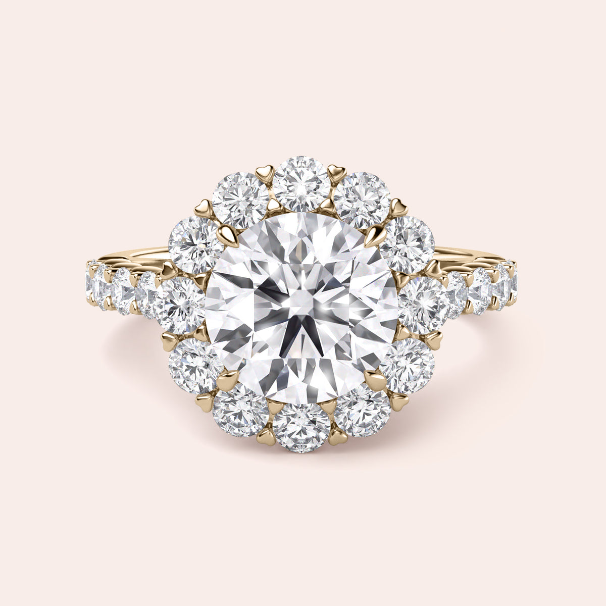 Elegant ring with a round diamond surrounded by a halo of smaller diamonds, available in 14K or 18K gold or platinum.