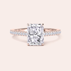 Elegant engagement ring with a radiant-cut diamond, set in a pave band, crafted from 14K or 18K rose gold or platinum.