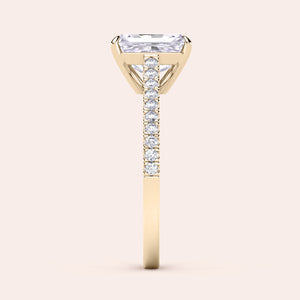 Side view of an elegant 14K or 18K gold and platinum ring with an elongated cushion diamond and sparkling smaller diamonds.