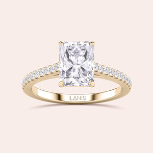 Radiant-cut diamond engagement ring in 14K gold with sparkling band, showcasing luxury and elegance on a neutral background.