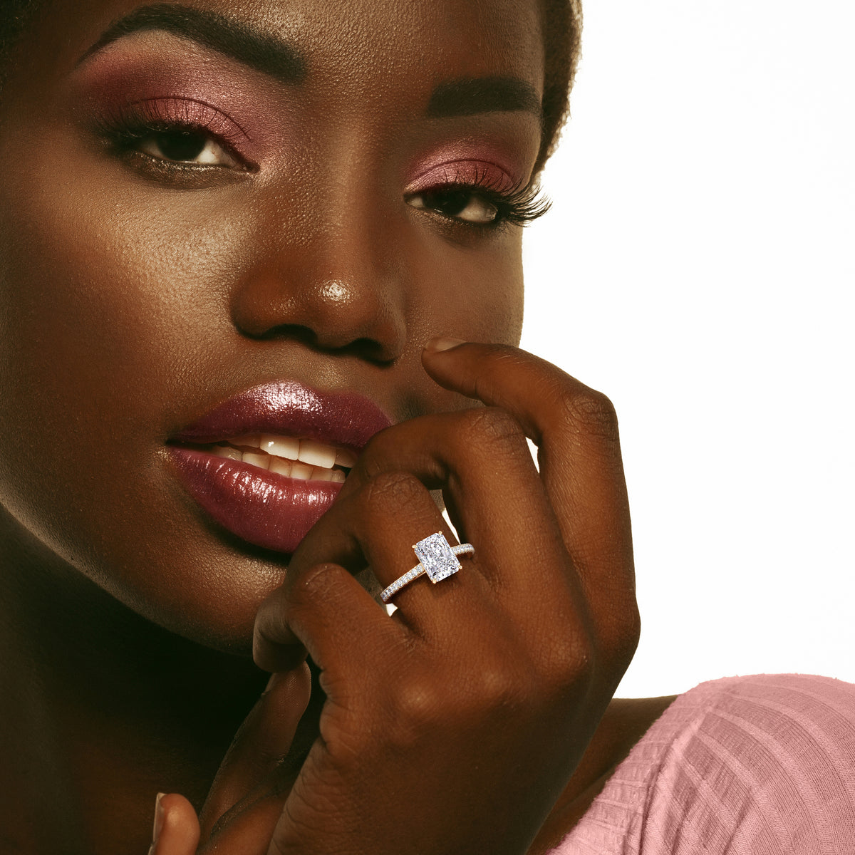 A stunning radiant-cut diamond ring in 14K or 18K gold or platinum, showcasing exquisite design and sophistication on a model's finger.