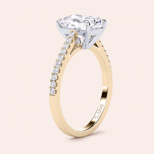 Two-tone 14K/18K gold engagement ring featuring a radiant-cut diamond in a cathedral setting with a pave diamond band. 