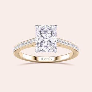 Two-tone 14K/18K gold diamond ring featuring a radiant cut stone in a cathedral setting with a pave diamond band. 