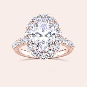 Luxurious oval-cut diamond halo ring in 14K or 18K rose gold or platinum, featuring a stunning array of round diamonds.