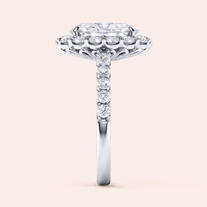 Elegant side view of a stunning 14K/18K white gold engagement ring with an elongated cushion cut diamond and halo of smaller diamonds.