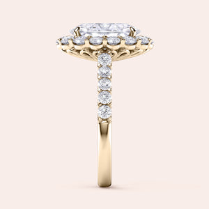 Elegant engagement ring with radiant-cut diamond, set in 14K or 18K yellow gold band, enhanced by sparkling round diamond halo.