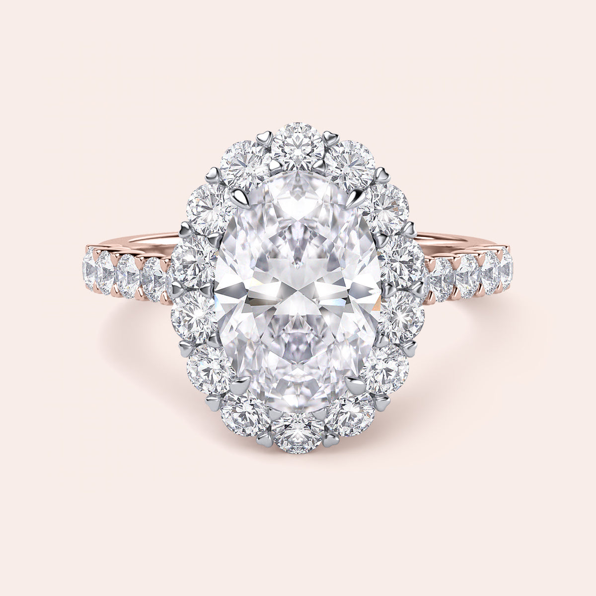 Two-tone 14K/18K white and rose gold oval diamond engagement ring with halo and pave band, displayed on a model's hand. 