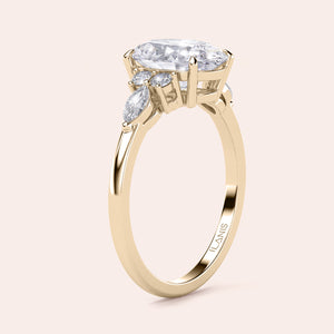 Gold engagement ring with oval-shaped diamond and marquise accents, available in 14K, 18K, or platinum for stunning elegance.