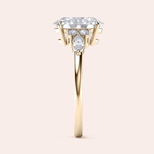 Elegant engagement ring with an emerald-shaped diamond in 14K or 18K gold or platinum, enhanced by captivating side stones.