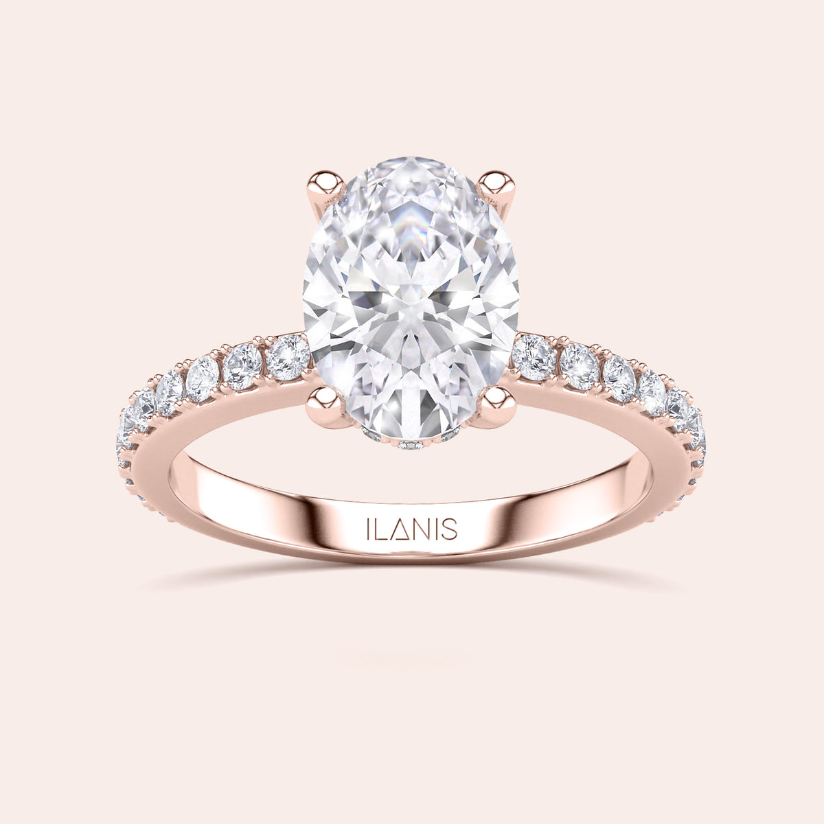 Elegant oval-shaped diamond engagement ring in 14K rose gold, with side diamonds. Available in 18K or platinum settings.