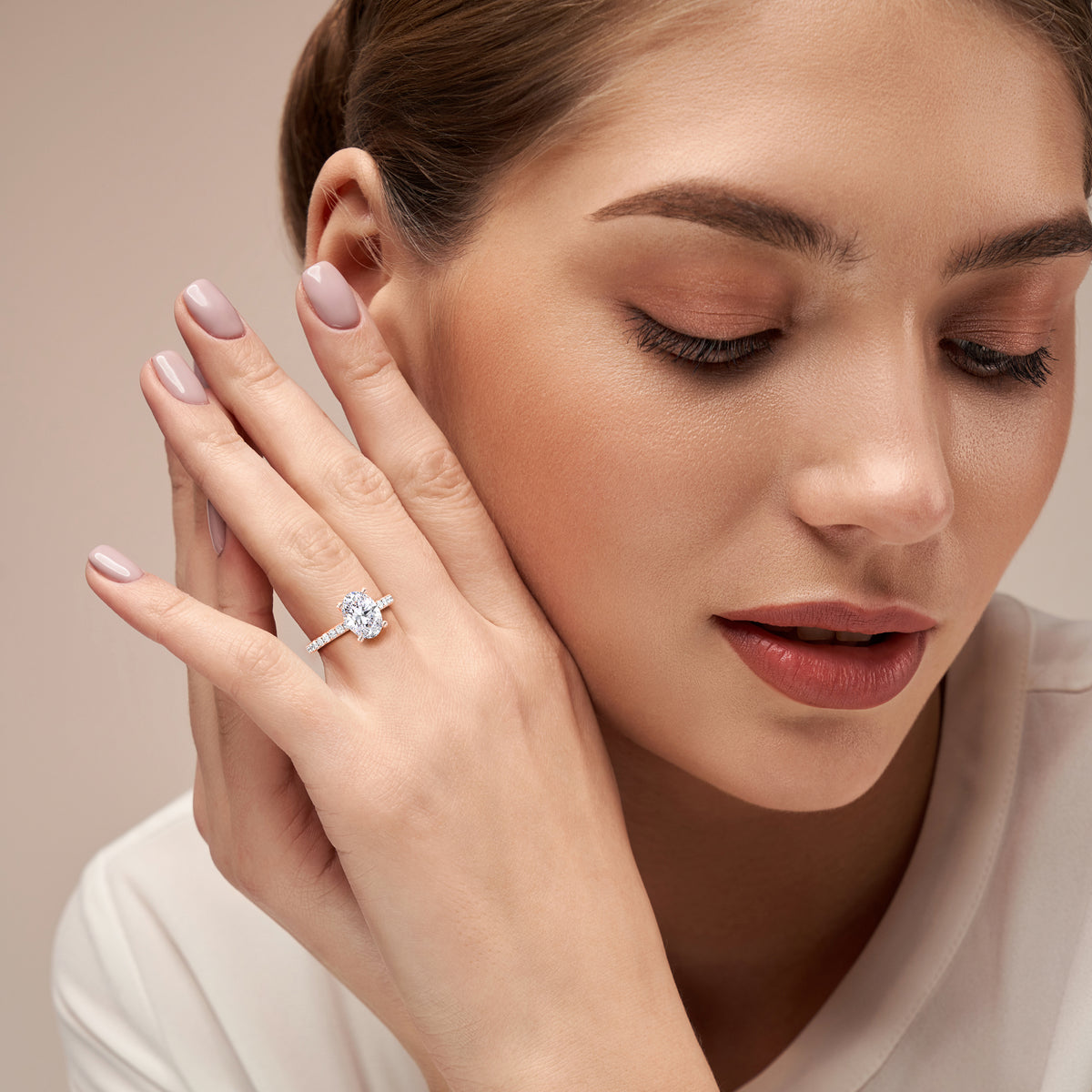 14K Gold ring with an oval diamond, elegantly worn on a model's hand, showcasing exquisite craftsmanship and timeless design.