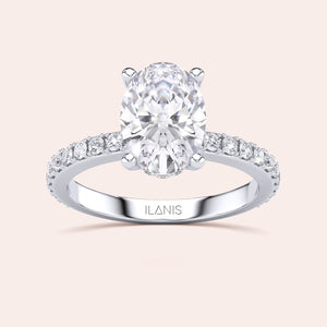 Elegant oval diamond engagement ring in 14K/18K gold or platinum, adorned with a delicate row of smaller diamonds on the band.