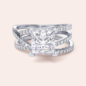 Elegant engagement ring with radiant-cut diamond in 14K or 18K gold or platinum, featuring a triple band and smaller diamonds.