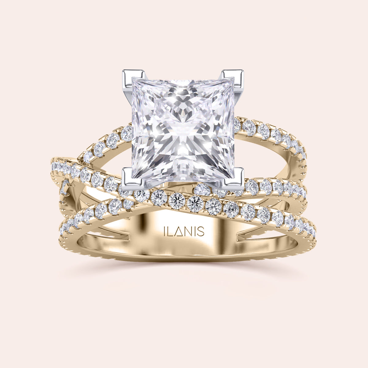 Two-tone 14K white and yellow gold diamond ring featuring a radiant-cut centerpiece and swirl pave diamond band. 