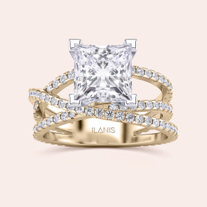 Two-tone 14K white and yellow gold diamond ring featuring a radiant-cut centerpiece and swirl pave diamond band. 