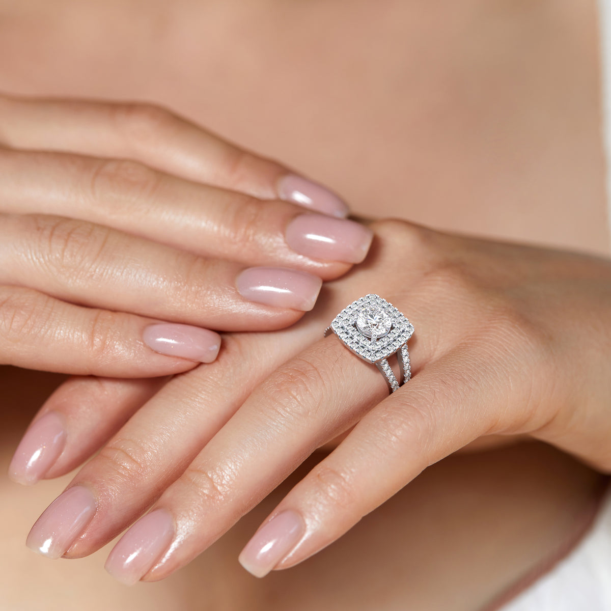 Elegant cushion-cut ring in 14K or 18K white gold, or platinum, with a radiant diamond centerpiece and intricate detailing.