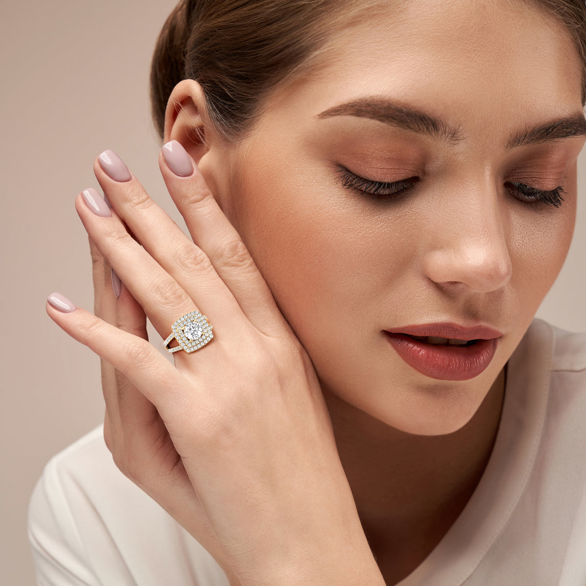 Elegant cushion-cut diamond halo ring in 14K/18K gold or platinum, showcasing timeless luxury and sophisticated craftsmanship.