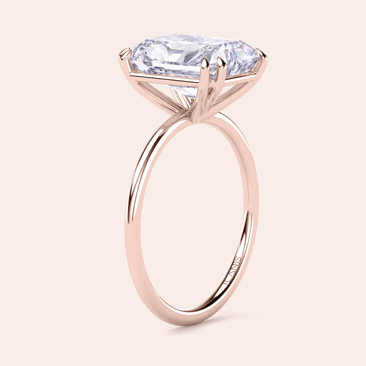 14K rose gold solitaire engagement ring featuring an emerald-cut diamond, also available in 18K gold or platinum. 