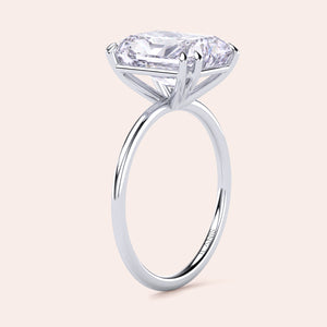 Elegant solitaire engagement ring with an oval diamond in 14K or 18K gold or platinum, showcasing timeless brilliance and design. 