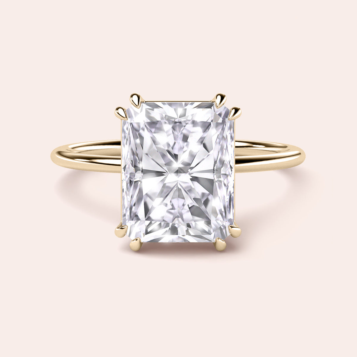 Radiant cut diamond ring in 14K or 18K gold or platinum, featuring an intricate prong setting on a neutral background.