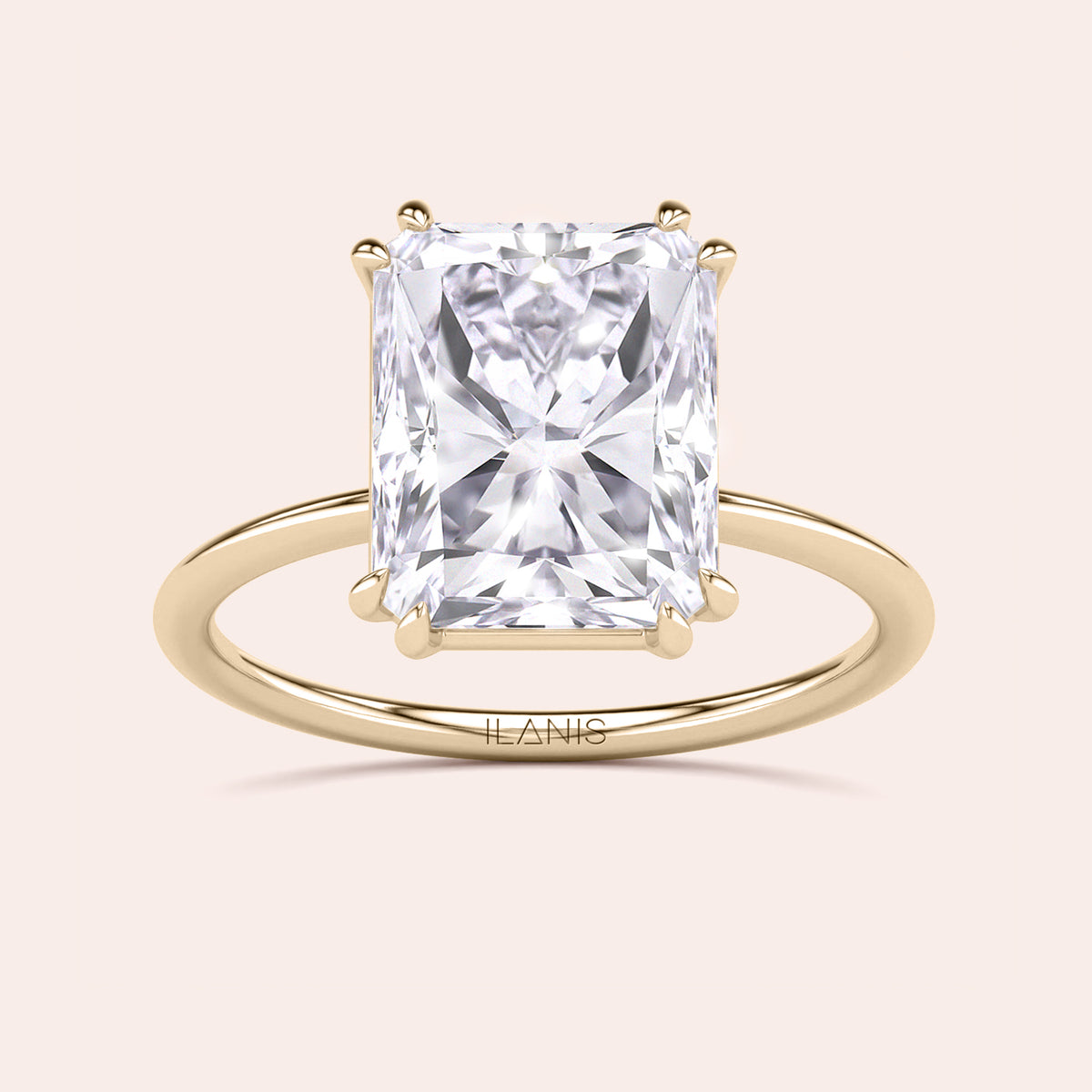 Elegant engagement ring with a radiant-cut diamond in a 14K or 18K yellow gold or platinum band, showcasing brilliance and sophistication.
