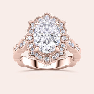 Front close-up of vintage oval halo diamond engagement ring featuring intricate filigree detailing in recycled rose gold 
