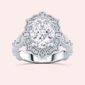 Front close-up of vintage oval halo diamond engagement ring featuring intricate filigree detailing in recycled rose gold 