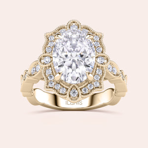 Front close-up of vintage oval halo diamond engagement ring featuring intricate filigree detailing in recycled rose gold 