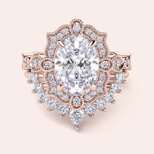 Front detailed view of oval halo diamond ring set featuring intricate vintage filigree and accent diamonds in recycled rose gold 