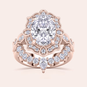 Detailed frontal view of oval halo diamond engagement ring set, highlighting exquisite craftsmanship and filigree accents in recycled rose gold 