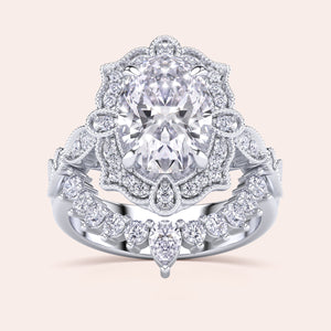 Detailed frontal view of oval halo diamond engagement ring set, highlighting exquisite craftsmanship and filigree accents in recycled white gold 