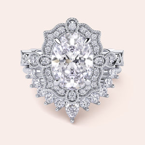 Front detailed view of oval halo diamond ring set featuring intricate vintage filigree and accent diamonds in recycled white gold 