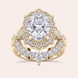 Detailed frontal view of oval halo diamond engagement ring set, highlighting exquisite craftsmanship and filigree accents in recycled yellow gold 