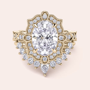 Front detailed view of oval halo diamond ring set featuring intricate vintage filigree and accent diamonds in recycled yellow gold 