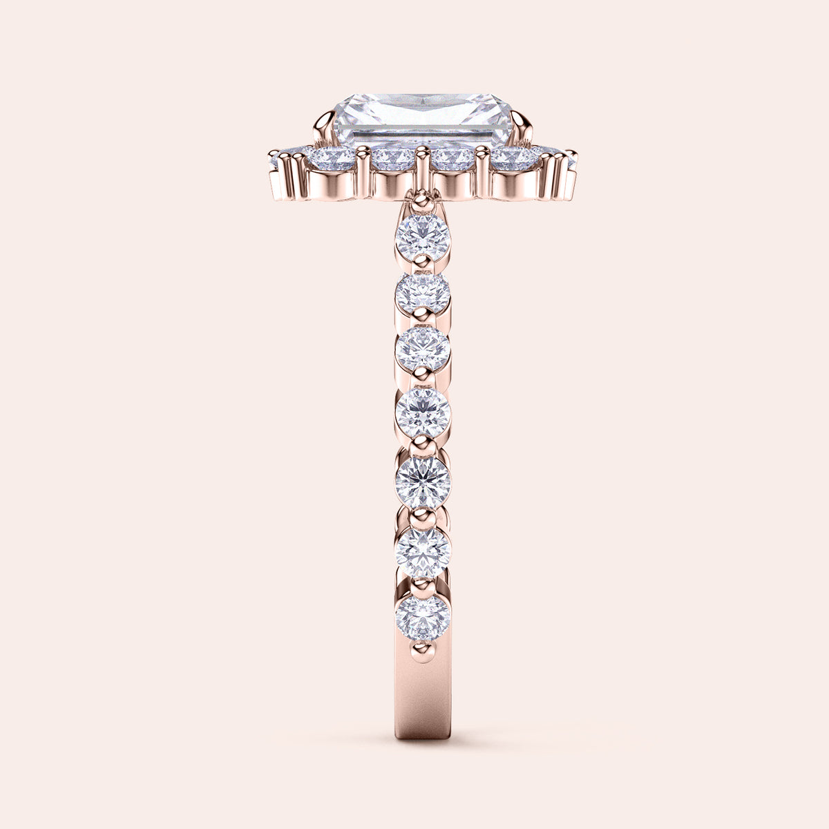 Side view of radiant-cut diamond halo engagement ring showcasing sparkling diamond band in rose gold 