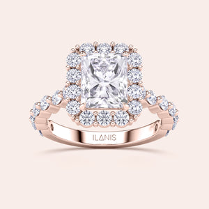 Detailed frontal close-up of radiant-cut halo diamond ring featuring a delicate diamond-accented band in rose gold 